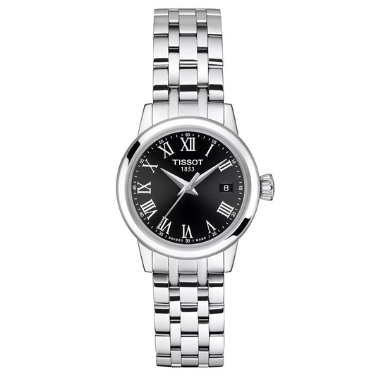 The Tissot Classic Dream Lady Quartz 28mm Watch features a silver-tone metal link band, black dial with white Roman numerals, Swiss Quartz movement, and a date display at 3 o’clock.