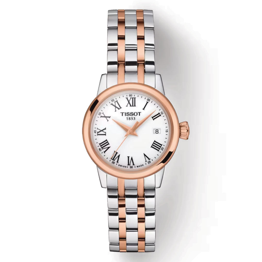 The Tissot Classic Dream Lady Quartz 28mm Watch epitomizes elegance with its silver and rose gold metal band. This enduring timepiece boasts a round face, white background, black Roman numerals, and a date display. The rose gold bezel tastefully highlights the "Tissot 1853" inscription on the dial, making it a quintessential addition to any watch collection.