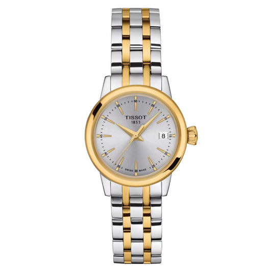 A Tissot Classic Dream Lady Quartz 28mm wristwatch featuring a two-tone stainless steel and gold bracelet, equipped with a scratch-resistant sapphire crystal. It has a round silver dial that displays gold hour markers and hands, along with a date window at the 3 o'clock position and "TISSOT 1853" inscribed on the face, powered by Swiss Quartz Movement.
