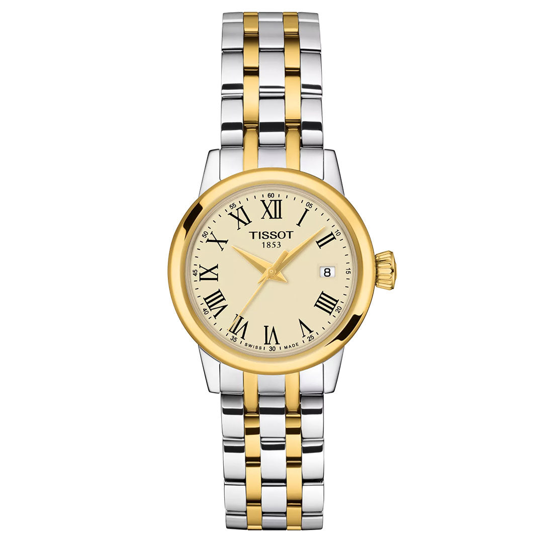 The Tissot Classic Dream Quartz 28mm Watch features a silver and gold two-tone metal band, round gold bezel, cream dial with black Roman numerals, date at 3 o'clock, and "Tissot 1853" on the face for a sophisticated look.