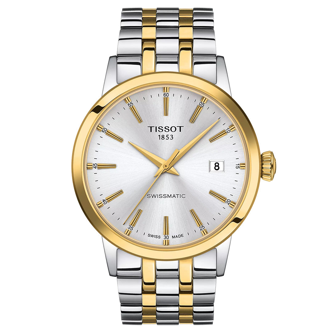 The Tissot Classic Dream Swissmatic 42mm Watch features a silver and gold 316L stainless steel band, silver dial with gold markers and hands, a gold bezel, and Swissmatic automatic movement with date at 3 o’clock.