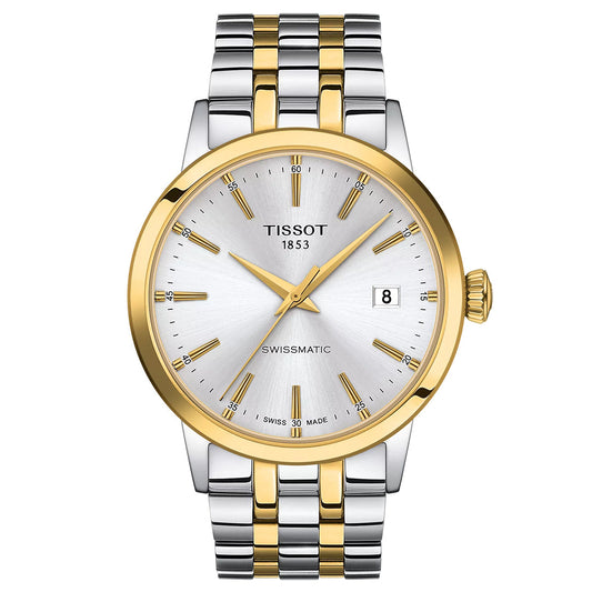 The Tissot Classic Dream Swissmatic 42mm Watch features a silver and gold 316L stainless steel band, silver dial with gold markers and hands, a gold bezel, and Swissmatic automatic movement with date at 3 o’clock.