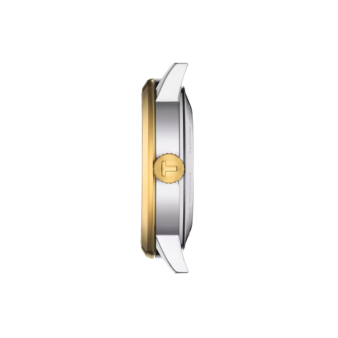 Side view of the Tissot Classic Dream Swissmatic 42mm Watch showcases a yellow gold PVD-coated crown and accents with silver metal, reflecting Tissot’s classic elegance, all set against a white background.