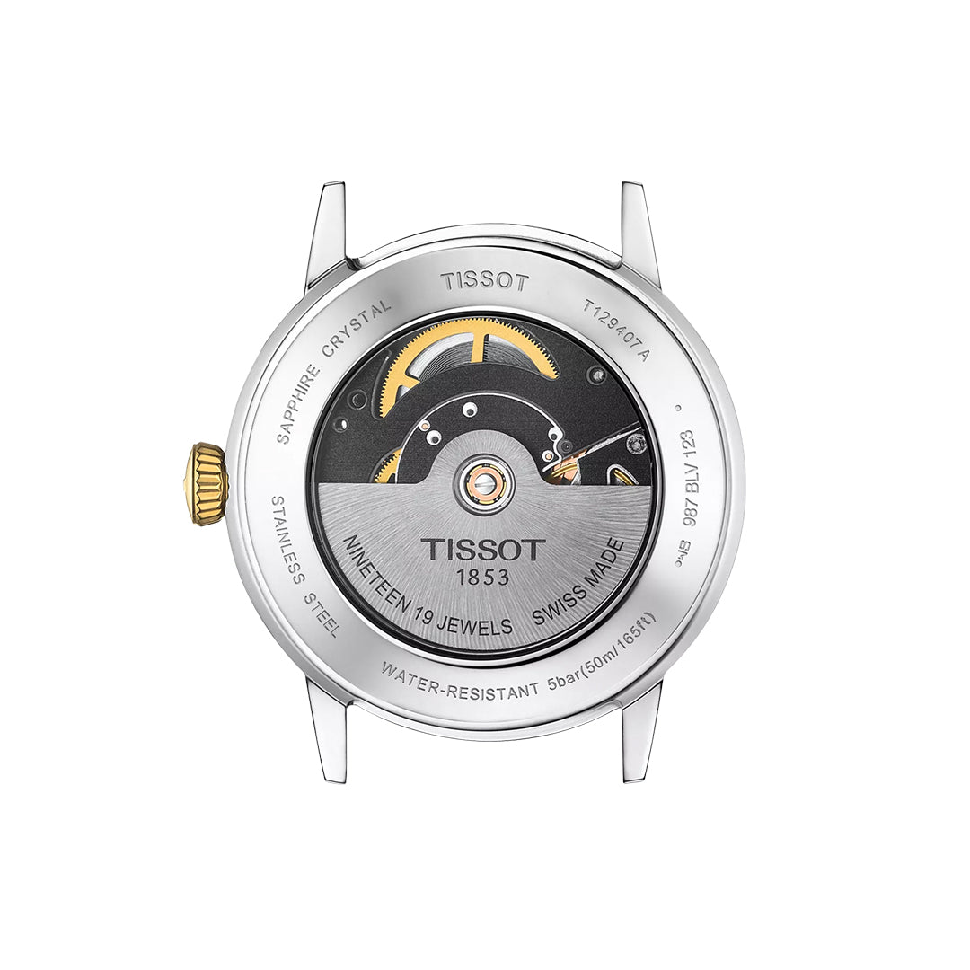 Back view of the Tissot Classic Dream Swissmatic 42mm Watch, showcasing a 316L stainless steel case, visible gold Swissmatic movement, engraved details, and a transparent sapphire crystal case back.