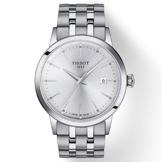 The Tissot Classic Dream Quartz 42mm Watch showcases a sleek, minimalist design with its silver metal bracelet and round white dial. It features silver hour markers and a date display at the 3 o'clock position. The face prominently displays "Tissot 1853," highlighting its Swiss Quartz Movement for precision.