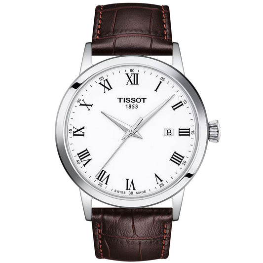 The Tissot Classic Dream Quartz 42mm Watch features a white dial with black Roman numerals, silver hands, Swiss Quartz movement, date at 3 o’clock, silver-toned bezel, brown leather strap, and "Tissot 1853" branding on the face.
