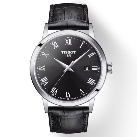 The Tissot Classic Dream Quartz 42mm Watch showcases a timeless design with its black leather strap and silver case. Perfect for everyday wear, the black dial is adorned with Roman numerals, minute markers, and a date window positioned at three o'clock. The watch hands and numerals have a sophisticated silver-tone finish.