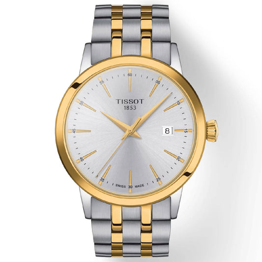 The Tissot Classic Dream Quartz 42mm Watch by Tissot features a silver face with gold hour markers, a date display, and a two-tone silver and gold metal bracelet. It is equipped with scratch-resistant sapphire crystal for durability and precise Swiss Quartz Movement for accurate timekeeping.