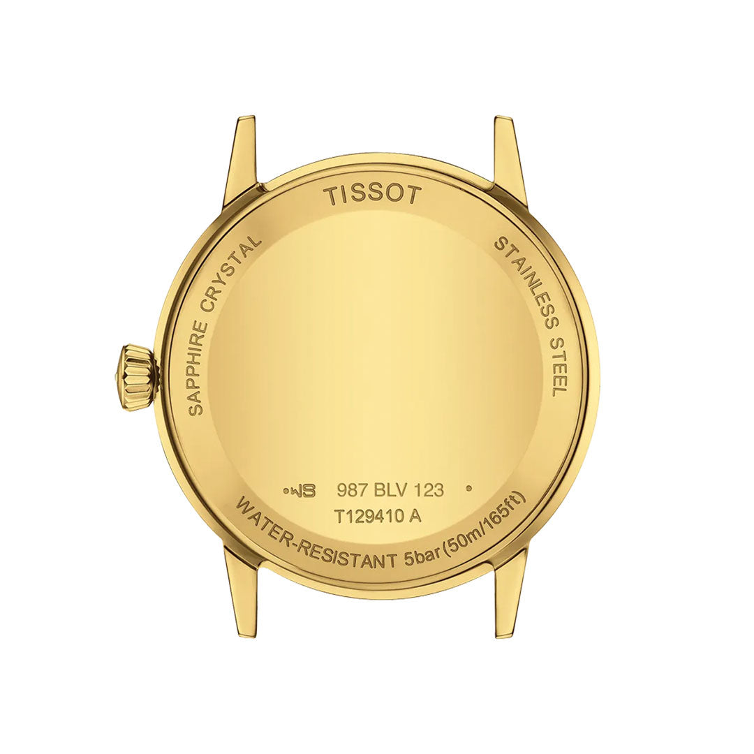 The Tissot Classic Dream Quartz 42mm Watch features a gold-toned case back inscribed with sapphire crystal, stainless steel, 5 bar (50m/165ft) water resistance, and model number T129410 A. Minimalistic design with no watch face or strap visible.
