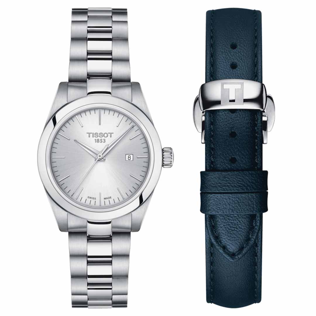 The Tissot T-My Lady Quartz 29mm Watch showcases a 316L stainless steel case and metal bracelet in silver, complemented by a minimalist dial with a date display at the 3 o'clock position. It features Swiss Quartz Movement and is protected by scratch-resistant sapphire crystal. Accompanying it is a dark blue leather strap with a silver "T" logo buckle from Tissot.