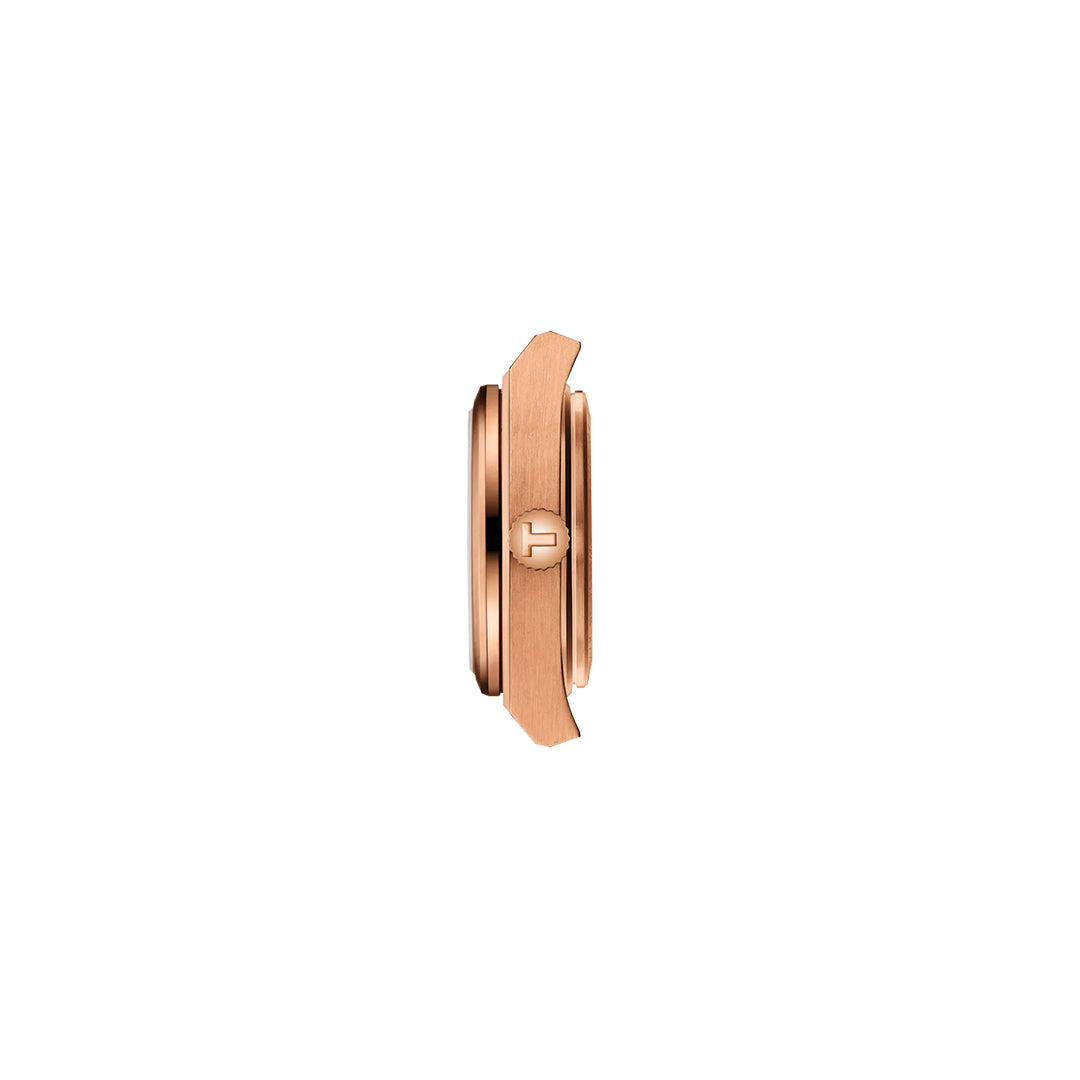 Side view of the Tissot PRX Quartz 25mm Watch in rose gold-tone stainless steel, featuring a textured crown with engraved "H" logo, quartz movement, and sapphire crystal by Tissot, shown on a white background.
