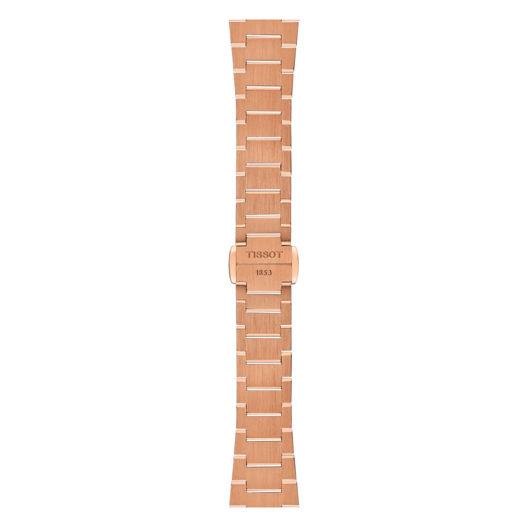 The Tissot PRX Quartz 25mm Watch features a rose gold metal band with a brushed finish, polished edges, and clasp engraved with the Tissot logo and "1853," designed for perfect pairing with its quartz movement.