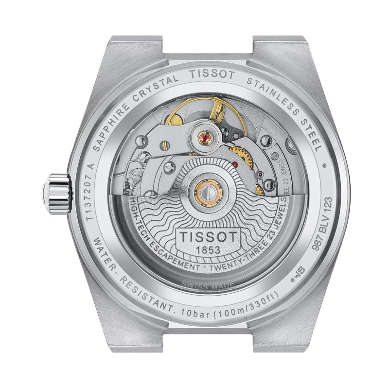 The image showcases the back view of a Tissot PRX Powermatic 80 Automatic 35mm Watch, revealing its detailed mechanical movement through a sapphire crystal case. The stainless steel case features engravings that include specifications such as water resistance and the year 1853, marking the founding of the Tissot brand.