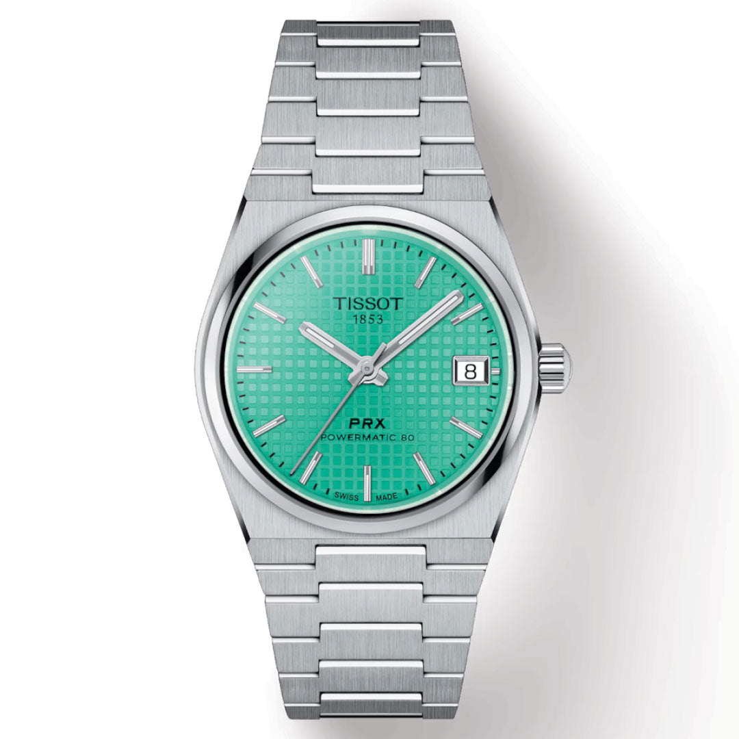 The Tissot PRX Powermatic 80 Automatic 35mm Watch includes a stainless steel band and turquoise dial, protected by a scratch-resistant sapphire crystal. The watch face displays a date window set to the 8th, features silver hour markers, and bears the "Tissot 1853 PRX Powermatic 80" inscription, highlighting its Swiss automatic movement.