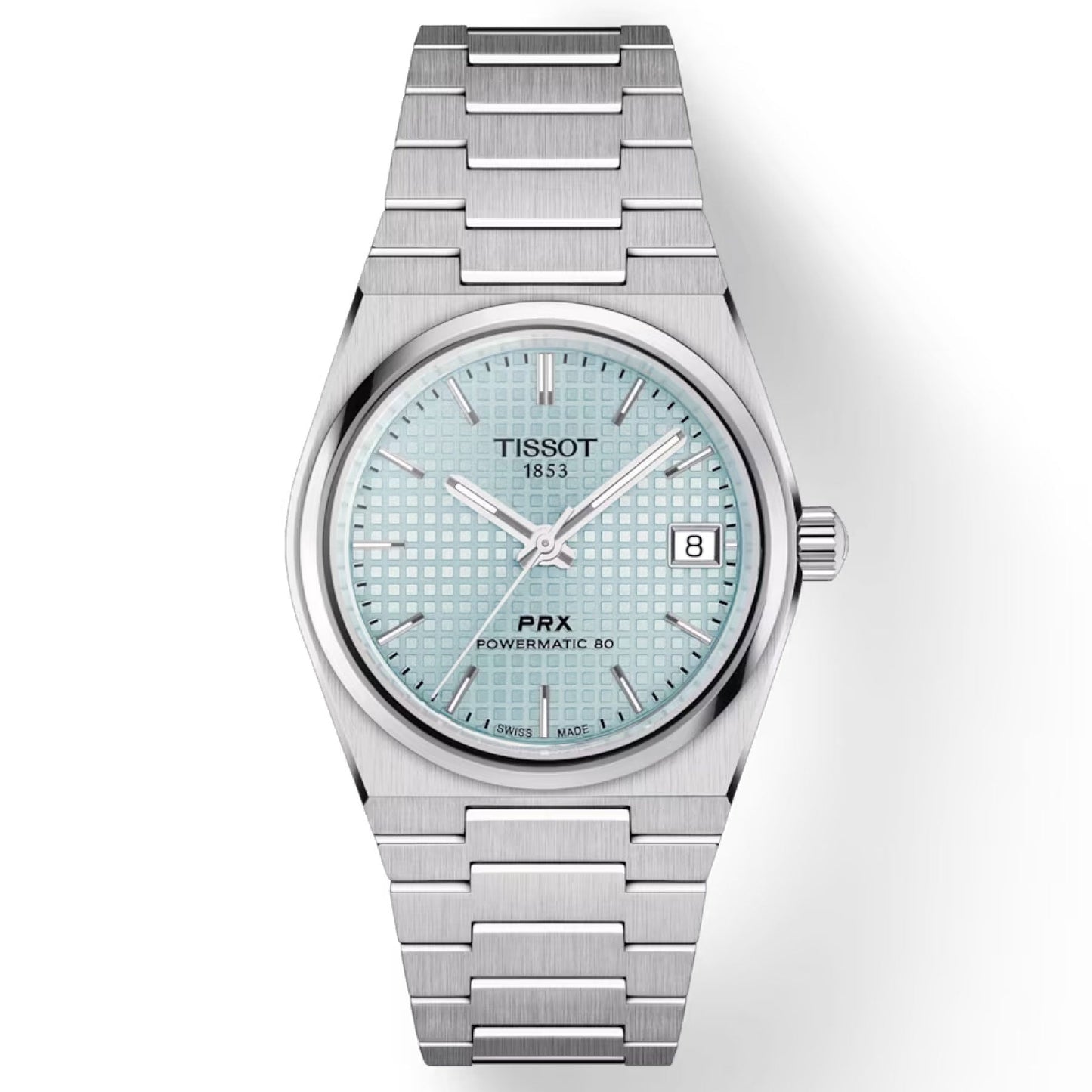 The Tissot PRX Powermatic 80 Automatic 35mm Watch by Tissot showcases a light blue patterned dial complimented by silver hour markers. Its face is safeguarded by a scratch-resistant sapphire crystal, with the date conveniently positioned at the 3 o'clock mark. The stainless steel case and bracelet add an elegant touch, while the dial is adorned with the Tissot logo and "1853.