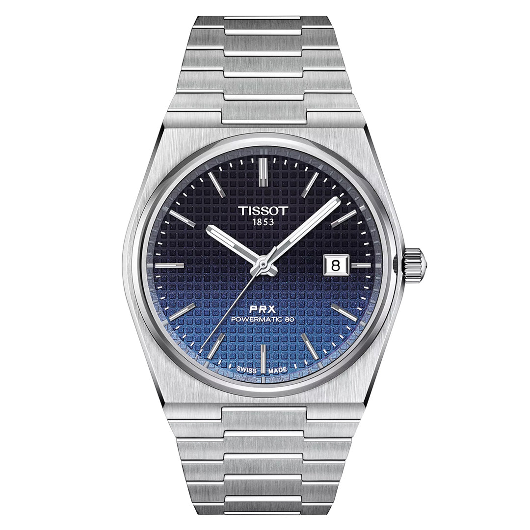 The Tissot PRX Gradient Powermatic 80 Automatic 40mm Watch by Tissot boasts a stainless steel link bracelet and showcases a black and blue gradient textured dial beneath a robust sapphire crystal. Silver hour markers and hands enhance the design, while an automatic movement powers the watch. It also features a date window at 3 o'clock.