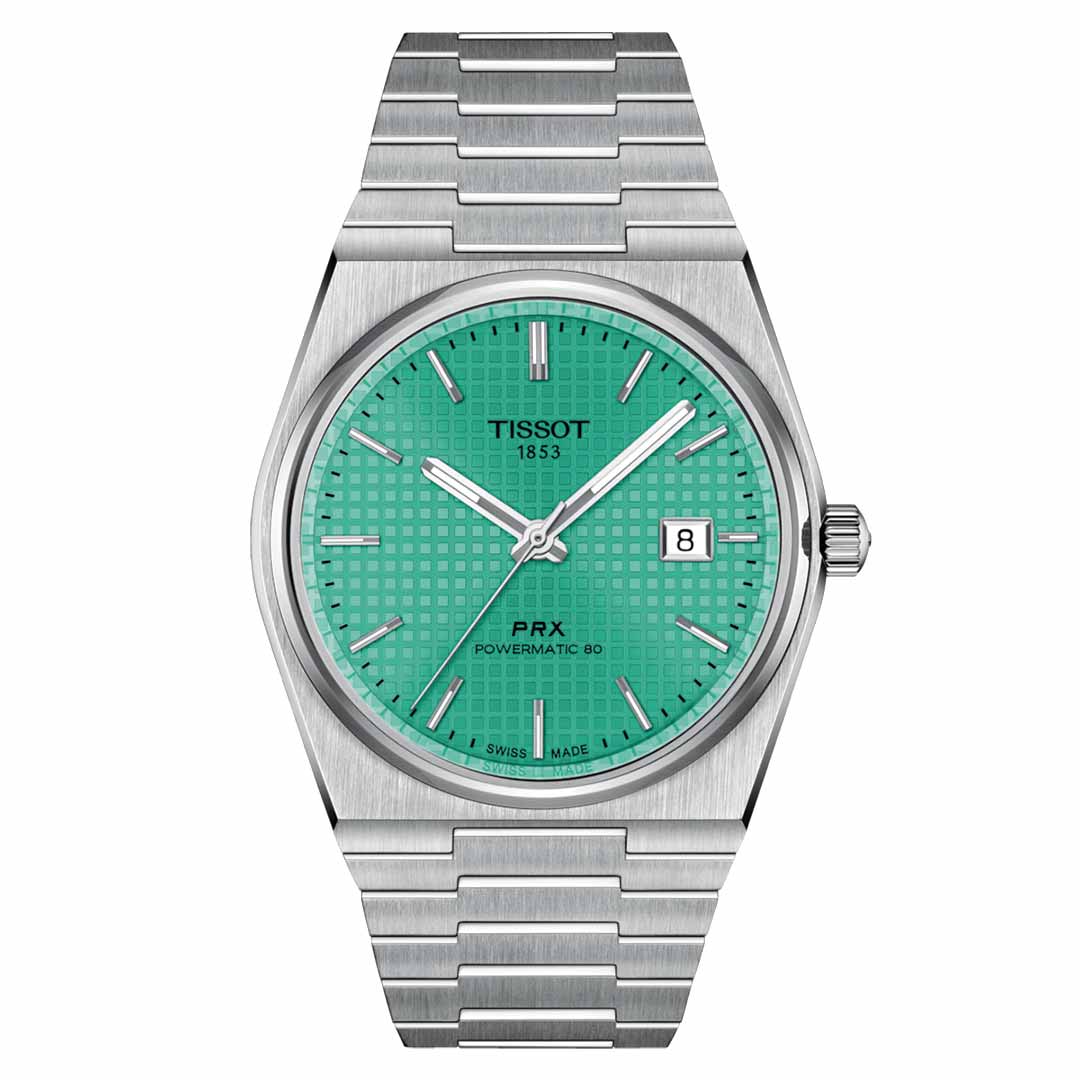 A Tissot PRX Powermatic 80 Automatic 40mm wristwatch featuring a scratch-resistant sapphire crystal and an eye-catching turquoise dial. This elegant timepiece includes silver hour markers, a date display at the 3 o'clock position, and the text "Tissot 1853 PRX Powermatic 80." It showcases Swiss automatic movement and offers versatility with its interchangeable quick-release bracelet.