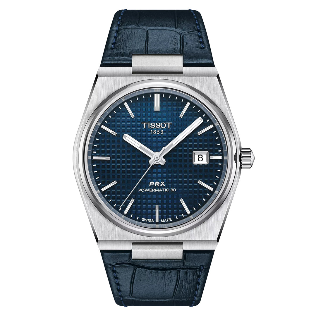 The Tissot PRX Powermatic 80 Automatic 40mm Watch features a textured blue dial with silver hour markers, a date display at three o'clock, and a stainless steel case. Its impressive power reserve pairs elegantly with the dark blue leather strap.