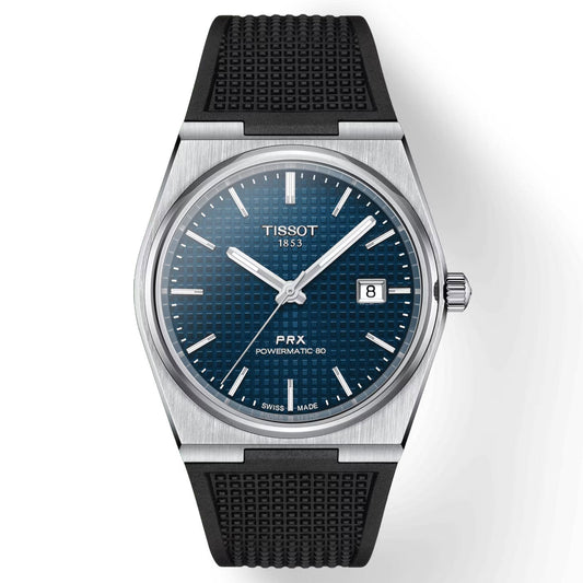 The Tissot PRX Powermatic 80 Automatic 40mm Watch by Tissot showcases a blue textured dial with silver hour markers and a date display positioned at 3 o'clock. It features an automatic movement and is paired with a black rubber strap. The stainless steel case is enhanced by silver-toned hands and safeguarded by sapphire crystal.