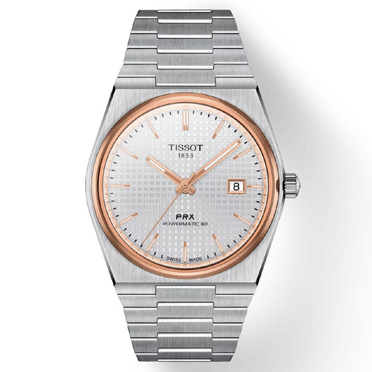 The Tissot PRX Powermatic 80 Automatic 40mm Watch features a stainless steel bracelet and a white patterned dial, highlighted by a rose gold bezel and hands. It is powered by its Swiss Automatic Movement for precise timekeeping, and includes a practical date display at the 3 o'clock position. The watch also boasts durability with its scratch-resistant sapphire crystal.