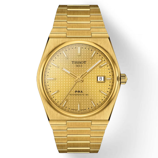 The Tissot PRX Powermatic 80 Automatic 40mm Watch features a gold design with a textured dial and integrated bracelet. It operates with an automatic movement, displaying the "Tissot" brand name on the watch face along with markers, hour and minute hands, a date window at the 3 o'clock position, and “PRX Powermatic” written on it. The watch also includes a scratch-resistant sapphire crystal.