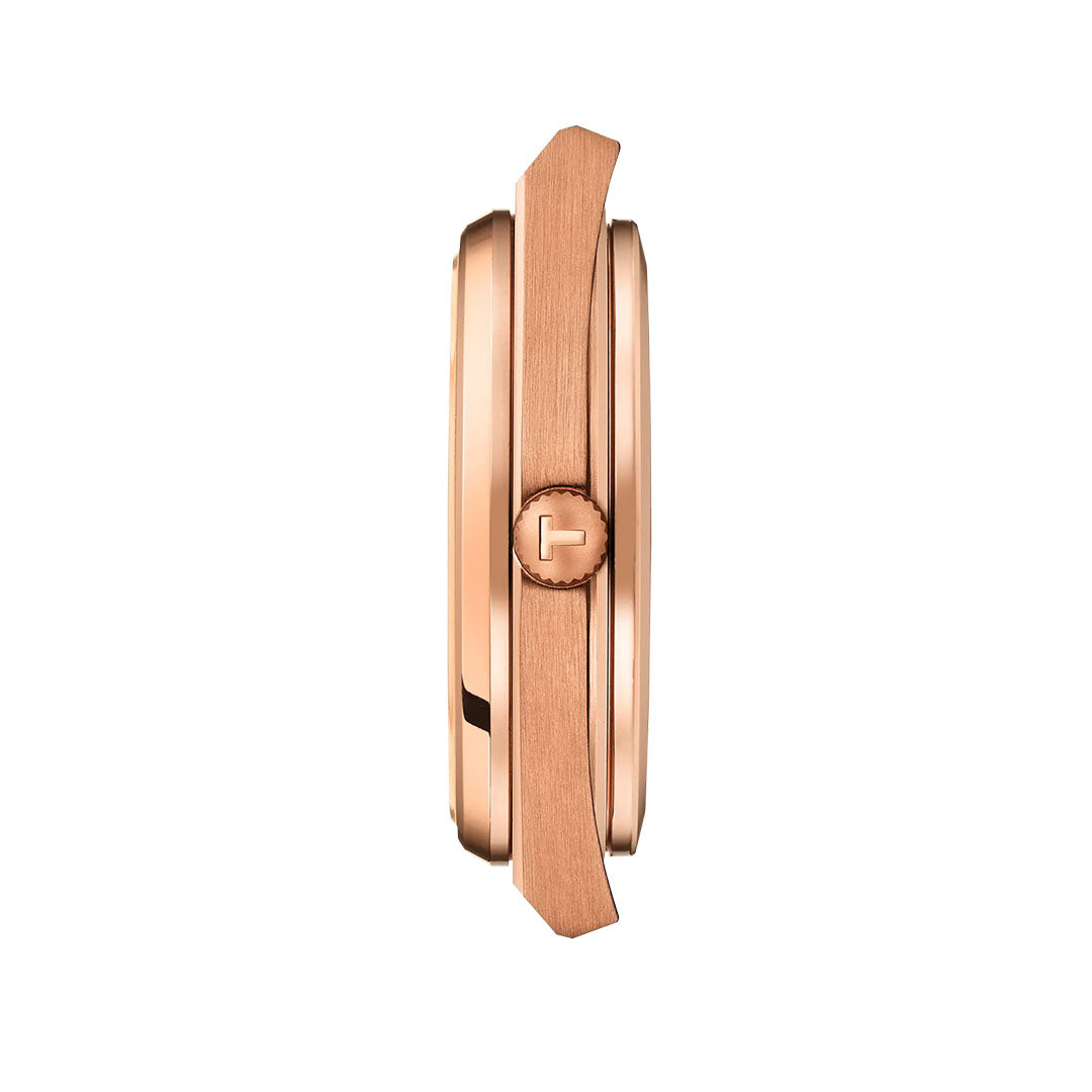 Side view of the Tissot PRX Powermatic 80 Automatic 40mm Watch in rose gold with a round crown engraved with a "T," displayed against a white background.