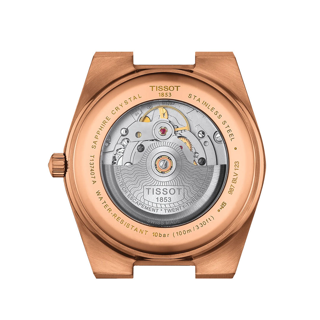 Close-up of the Tissot PRX Powermatic 80 Automatic 40mm Watch back, showing its transparent case revealing the automatic movement, surrounded by rose gold-tone metal and engraved with technical details.
