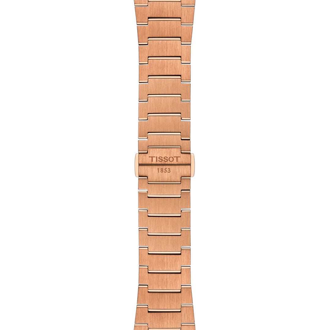 A rose gold metal band with rectangular links and a polished finish, engraved “TISSOT 1853,” is the ideal accessory for your Tissot PRX Powermatic 80 Automatic 40mm Watch.