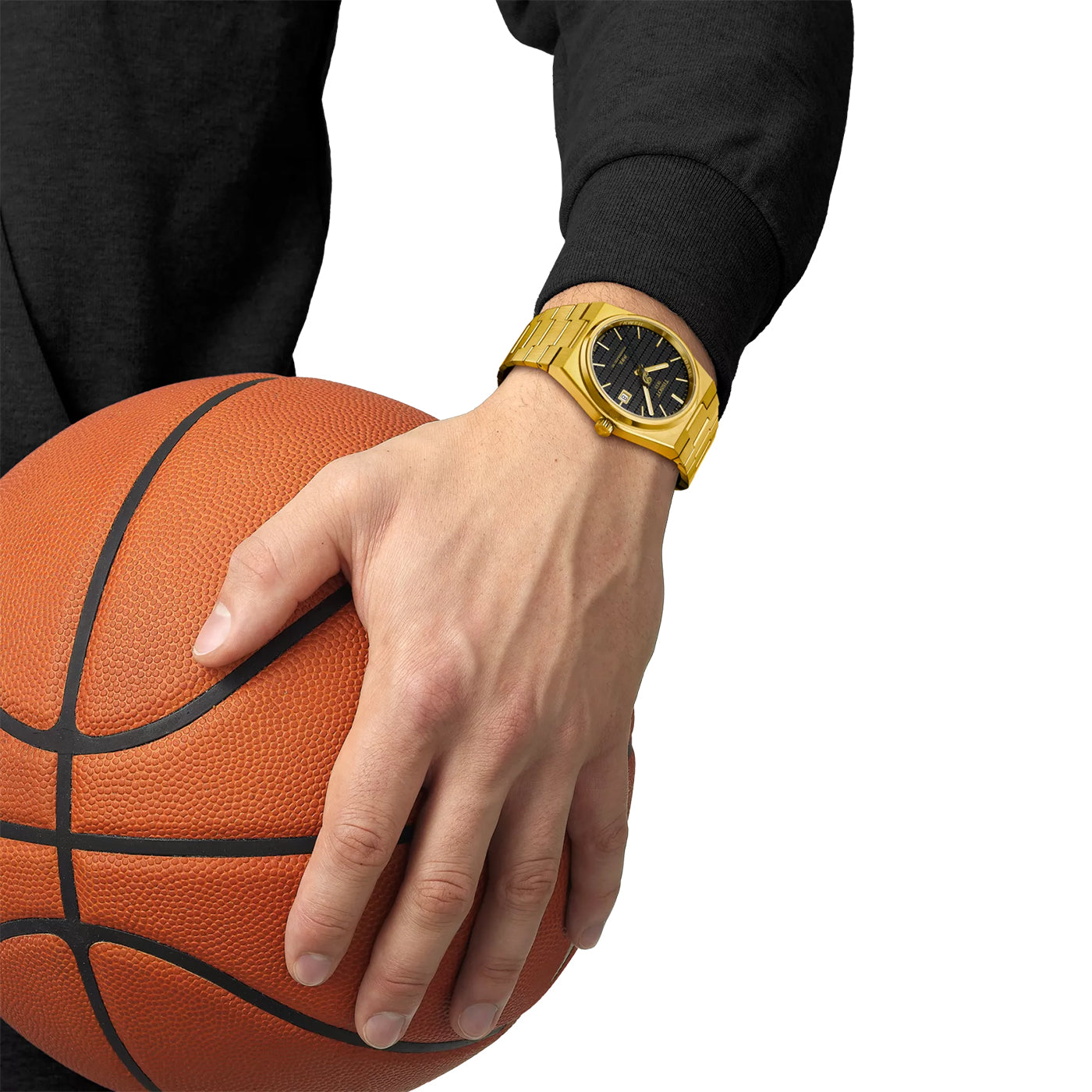 Clad in a black sweatshirt, they hold a basketball with their left hand, epitomizing Dame Time. On their wrist is a Tissot PRX Powermatic 80 Damian Lillard Special Edition watch, exuding sophistication with its gold features and sleek black face.