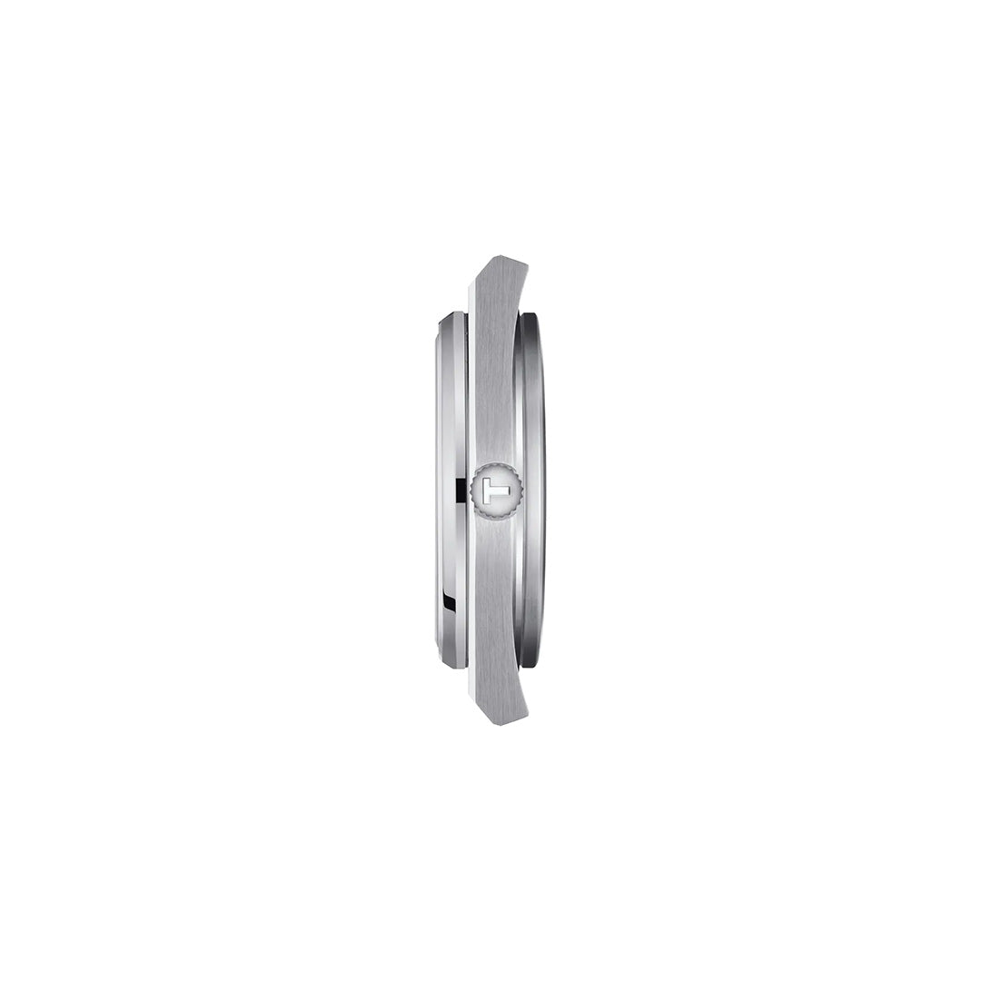 Side view of a round, silver-toned Tissot PRX Quartz 40mm watch case with a prominent ridged crown. The slim profile of this Tissot timepiece appears thin and sleek against a plain white background—an elegant highlight now available at Raffi Jewellers.