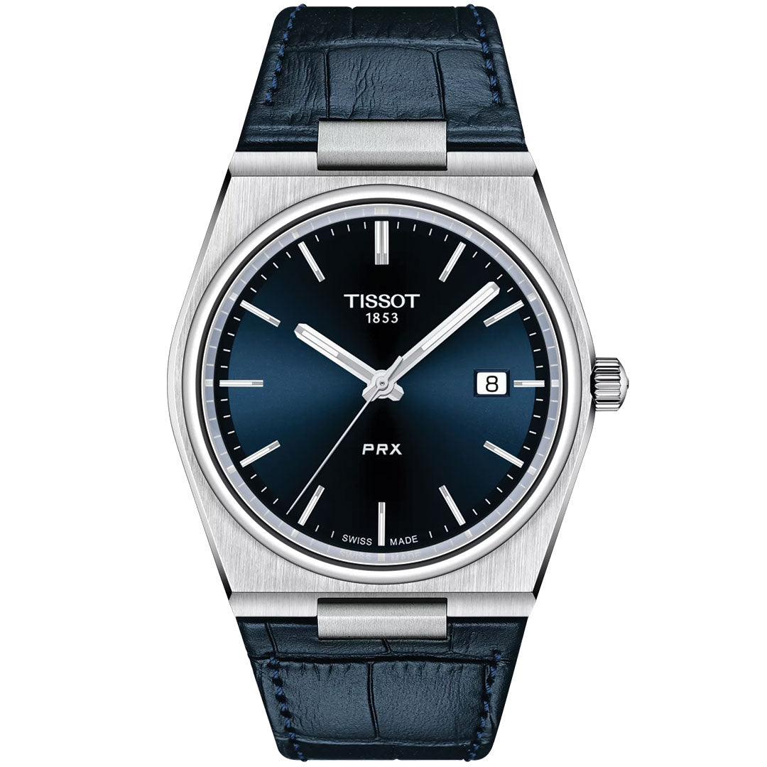 The Tissot PRX Quartz 40mm Watch features a blue leather strap, 316L stainless steel case, blue dial with silver hour markers and hands, plus a date display at 3 o’clock.