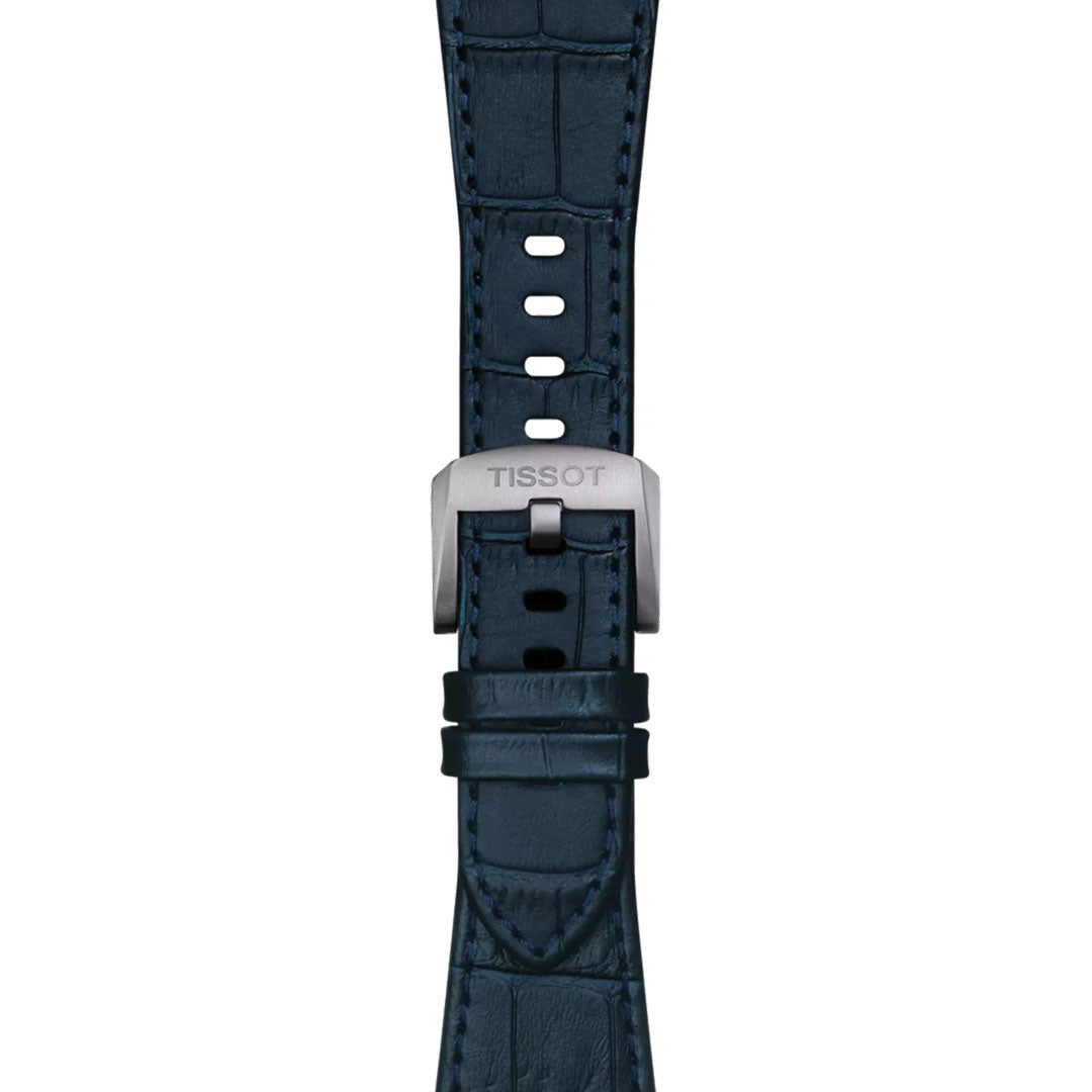 Close-up of the Tissot PRX Quartz 40mm Watch, showing a dark blue crocodile-patterned leather strap with a silver Tissot-engraved buckle, paired with a refined 316L stainless steel case.