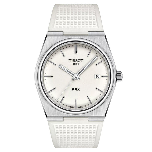 The Tissot PRX Quartz 40mm Watch, a silver model with a white textured strap, boasts a slim design featuring a white dial with silver hour markers, date at 3 o'clock, and the Tissot logo above center, blending sleek modernity with modern-vintage style.