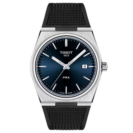 The Tissot PRX Quartz 40mm Watch by Tissot pairs a blue gradient dial with silver markers and hands, Swiss quartz movement, a date window at 3 o’clock, and a black textured rubber strap in a brushed silver-toned case for a modern-vintage look.