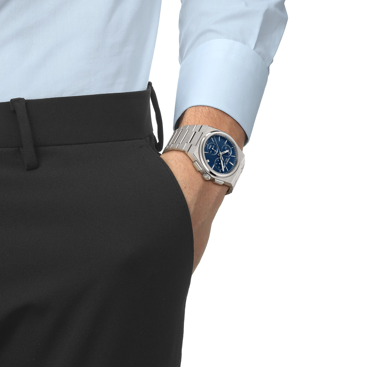 A Tissot PRX Chronograph Quartz 41mm Watch with a silver finish, blue dial, and metal link bracelet worn on a wrist.