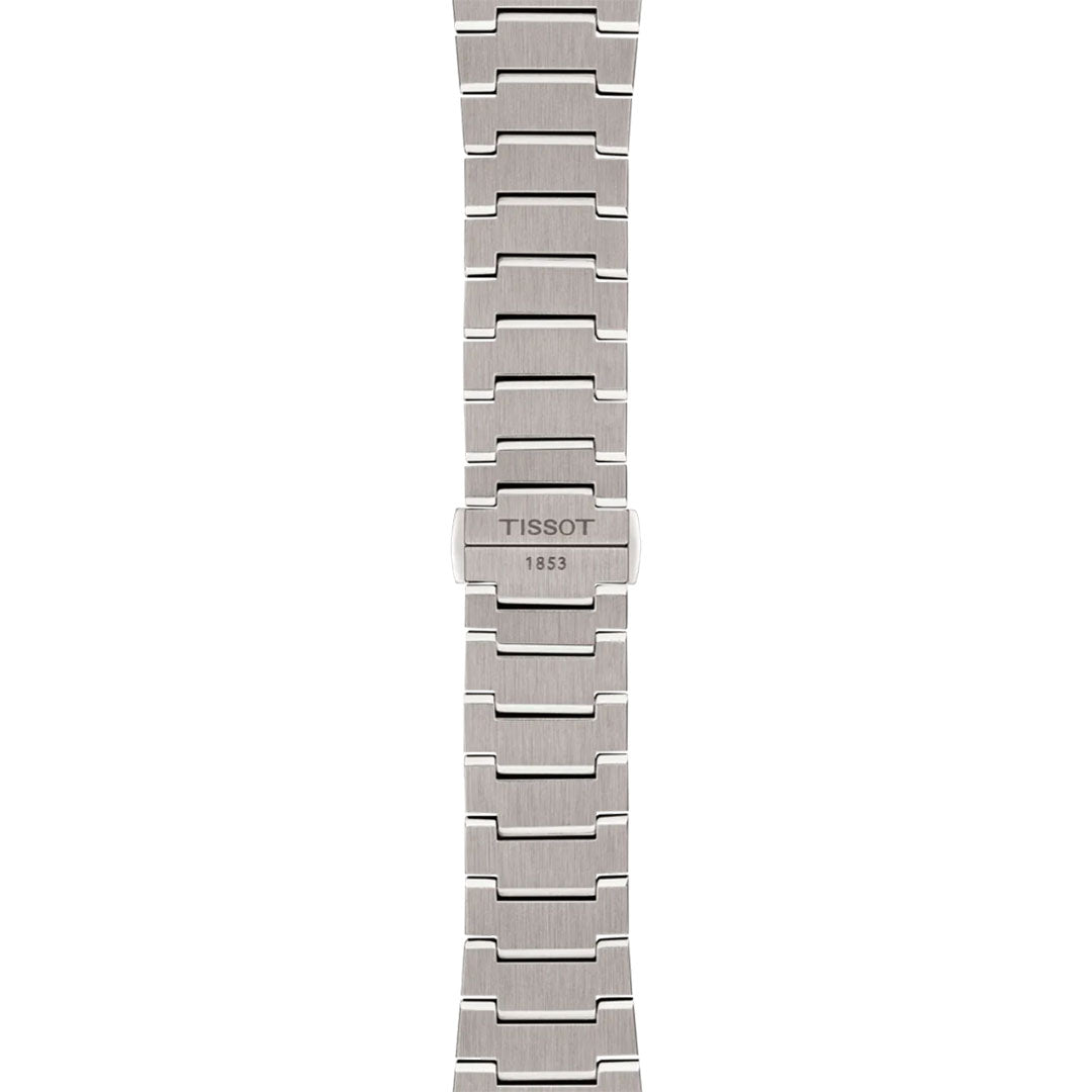 The Tissot PRX Titanium Powermatic 80 Automatic 38mm Watch features a silver metal band with rectangular links, a central clasp engraved "Tissot 1853," and a brushed finish for modern style.
