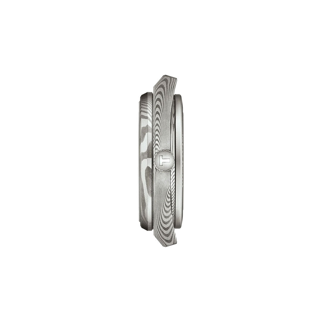 Side view of the Tissot PRX Damascus Steel Powermatic 80 Automatic 38mm Watch, showcasing its marbled Damascus stainless-steel case with a patterned finish and embossed "T" crown, set against a plain white background.