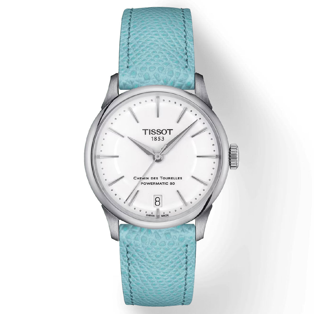 The Tissot Chemin Des Tourelles Powermatic 80 Automatic 34mm Watch features a white dial with silver casing, complemented by silver hour markers and hands. It includes a date window at the 6 o'clock position and showcases "Chemin Des Tourelles Powermatic 80" on the face. This watch is equipped with a textured light blue strap and is driven by the Swiss automatic Powermatic 80 movement.