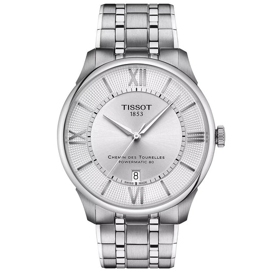 The Tissot Chemin Des Tourelles Powermatic 80 Automatic 42mm Watch features a silver-tone stainless steel band, Roman numerals at 12, 3, 6, and 9, a date display at 6 o’clock, and a scratch-resistant sapphire crystal face.
