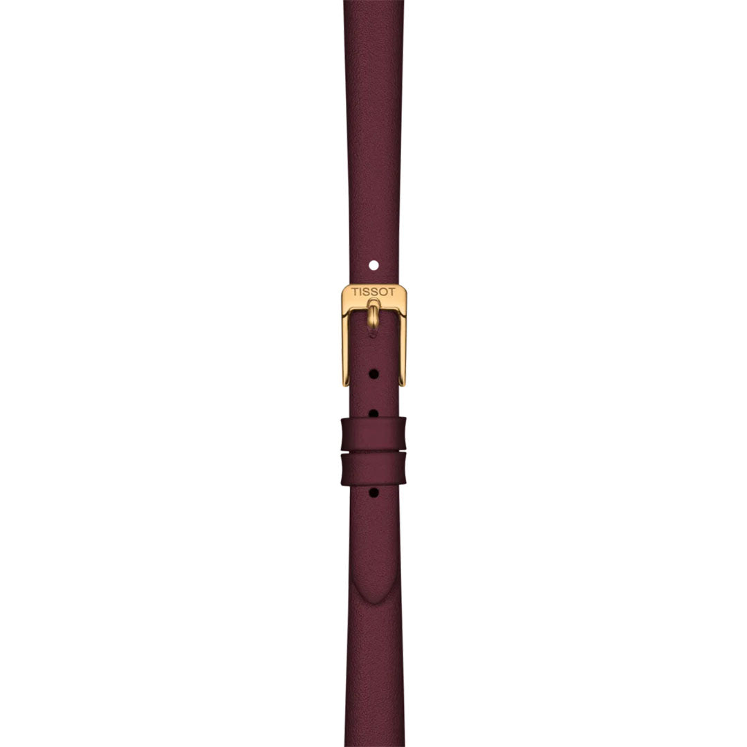 A Tissot Lovely Round Quartz 19.5mm Watch, featuring a burgundy leather strap and gold buckle engraved with the Tissot logo, is shown vertically against a white background—ideal for pairing with matching burgundy dials.
