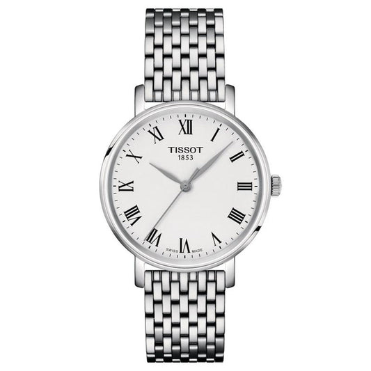 The Tissot Everytime Quartz 34mm is a silver women's watch with a white dial, Roman numerals, three hands, metal link bracelet, and the "TISSOT 1853" logo. The face also displays "Swiss Made.