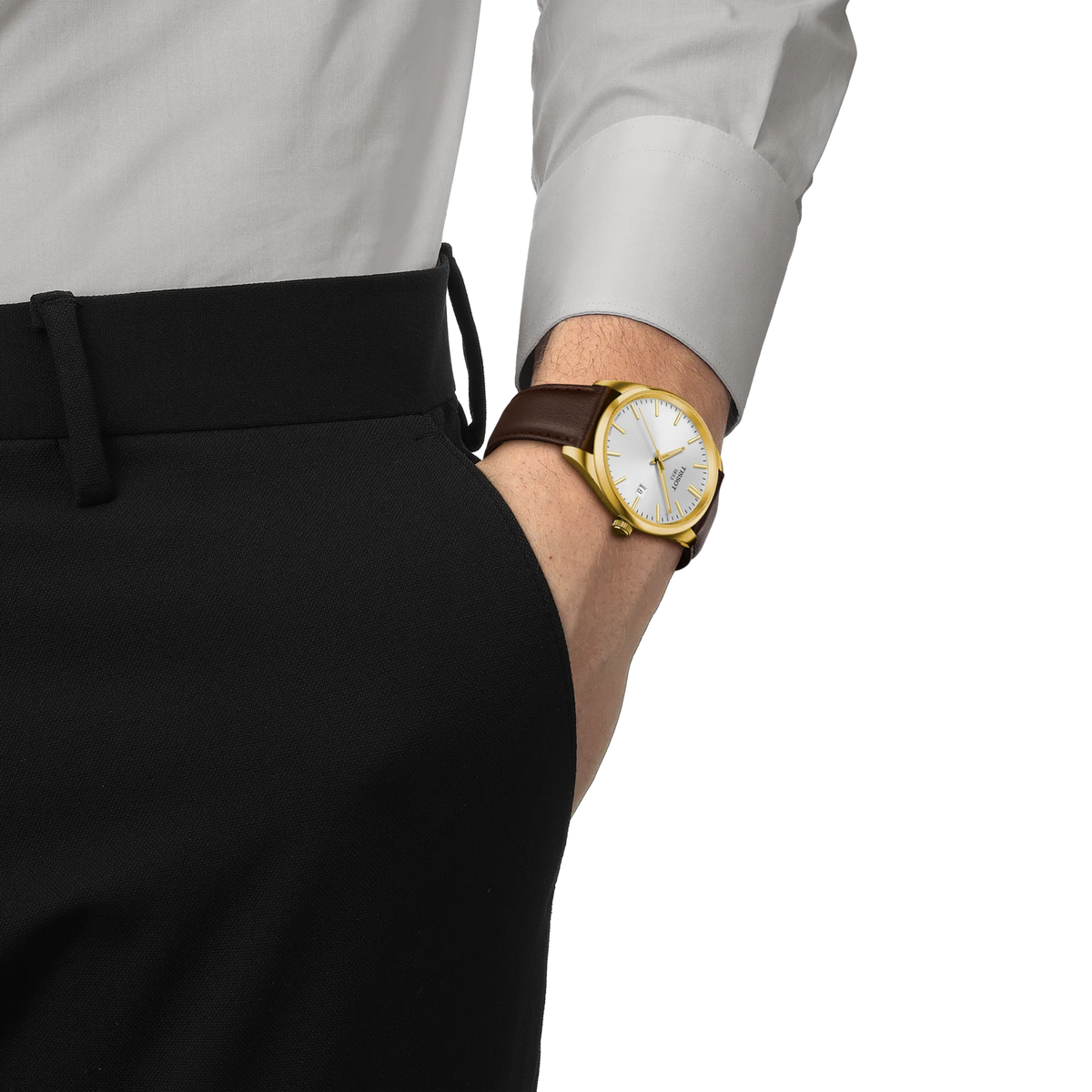 A person wearing a gold-tone Tissot PR100 Quartz 40mm Watch with a white dial and a brown leather strap on their wrist.