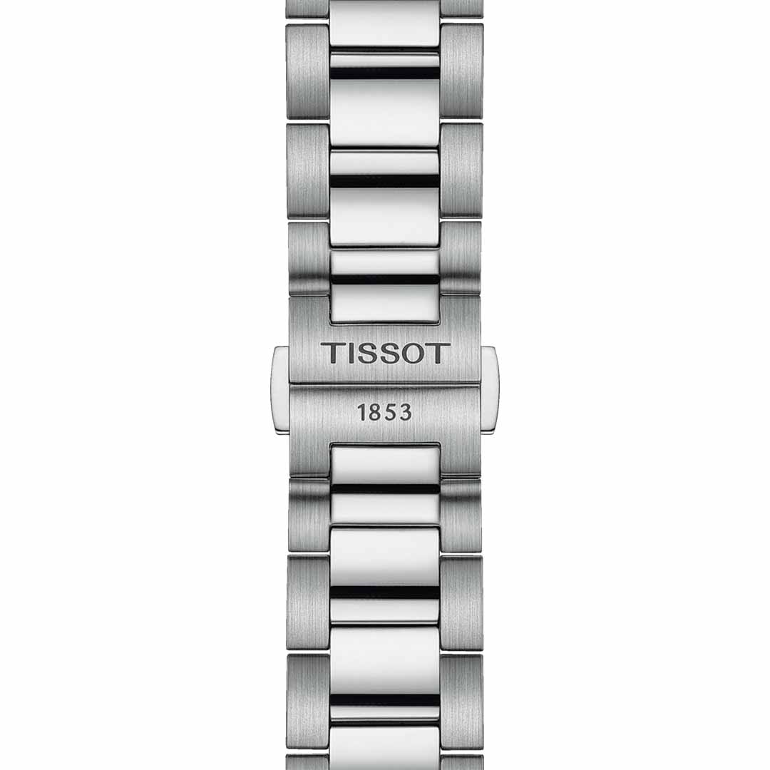 Close-up of the Tissot PR100 Chronograph Quartz 40mm watch strap in silver metallic, showcasing the "Tissot" engraving on the center link followed by "1853." The bracelet boasts a sophisticated design with alternating polished and brushed metal links, further enhanced by Super-LumiNova® coating for improved visibility.