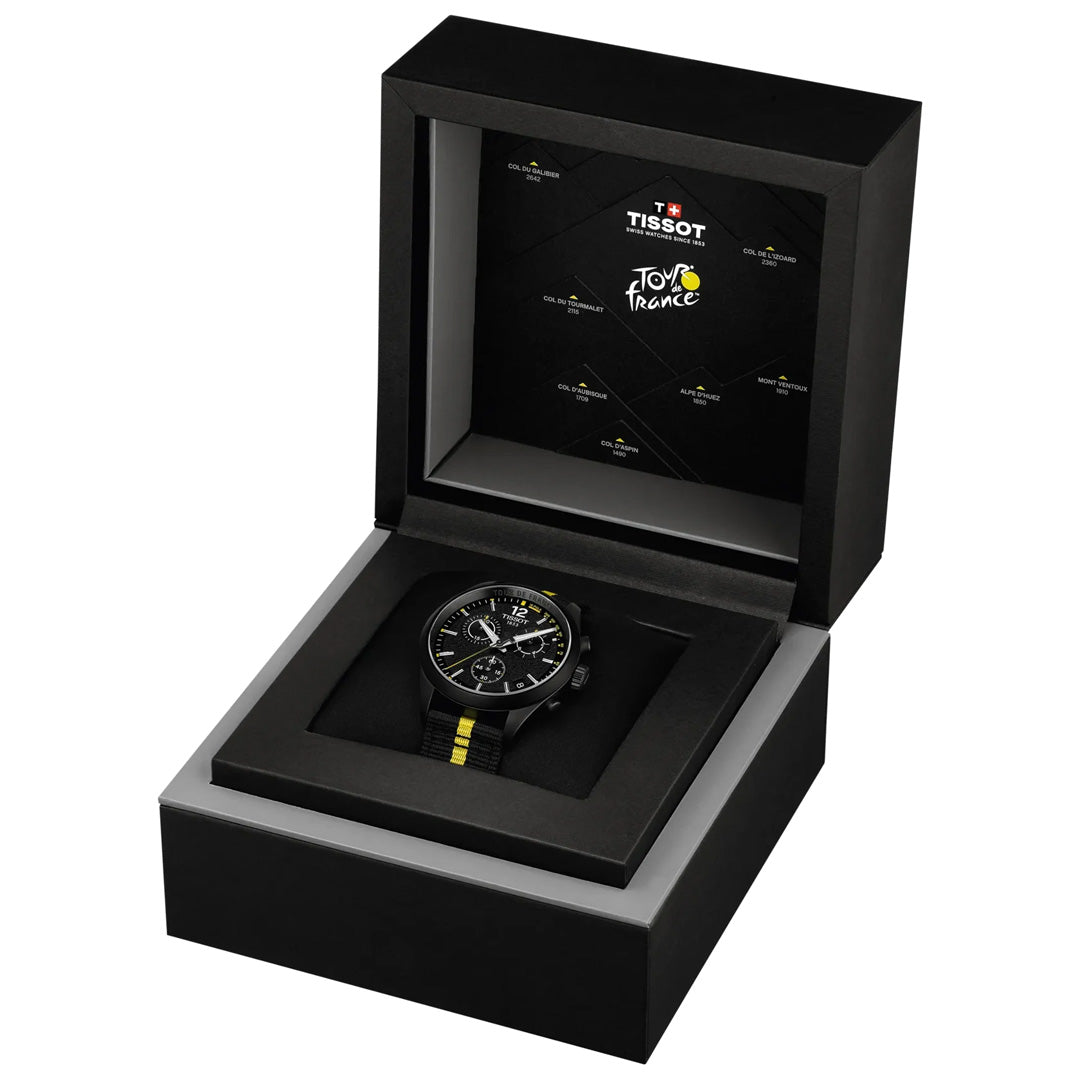 A Tissot PR100 Chronograph Tour De France 2026 Quartz 40mm Watch—an eye-catching cycling timepiece—rests in an open black presentation box, which features the Tour de France logo inside the lid.