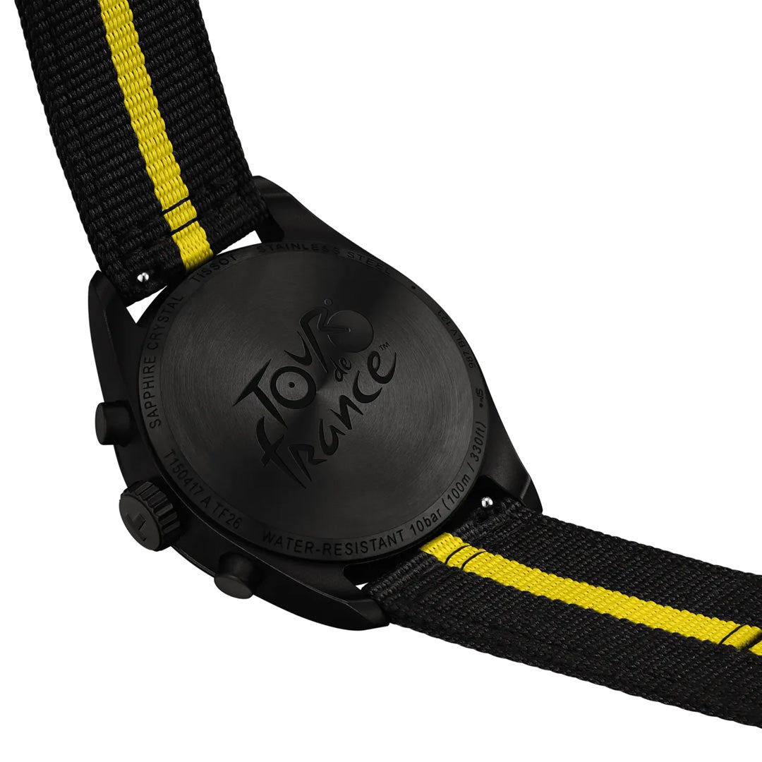 The back of the Tissot PR100 Chronograph Tour De France 2026 Quartz 40mm Watch is engraved with "Tour de France." This eye-catching Tissot cycling timepiece showcases a black and yellow fabric strap, as well as details on its water resistance and sapphire crystal on the case.