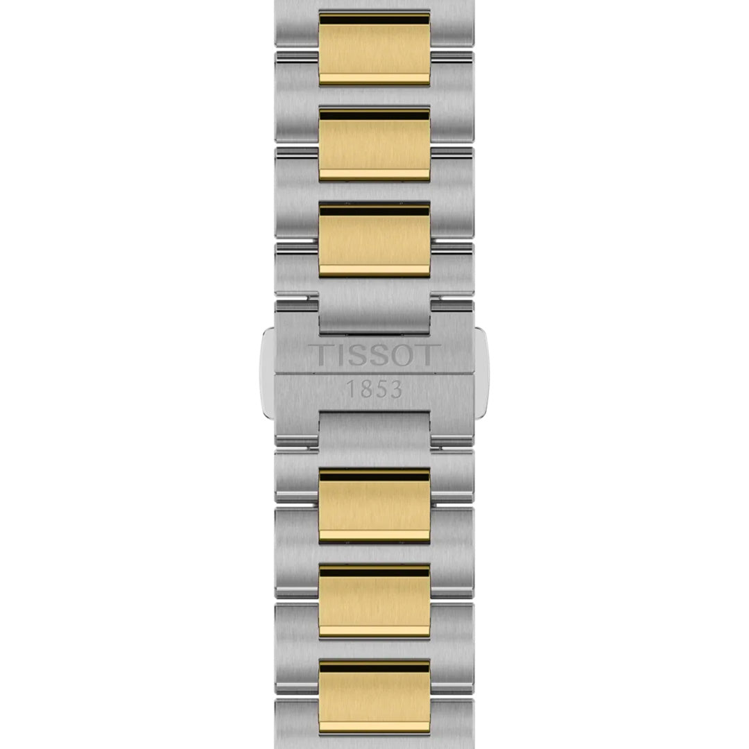A close-up of the Tissot PRC 100 Solar Quartz 39mm Watch bracelet shows alternating silver and gold-tone links, with "TISSOT 1853" engraved on the clasp.