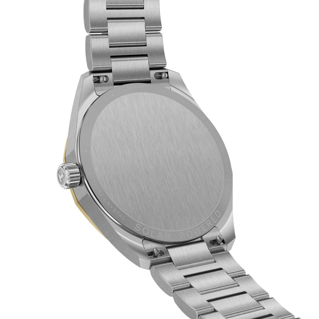 The back view of a Tissot PRC 100 Solar Quartz 39mm watch displays its engraved "SOLAR POWERED" caseback and metal link band, with the crown visible on the left.
