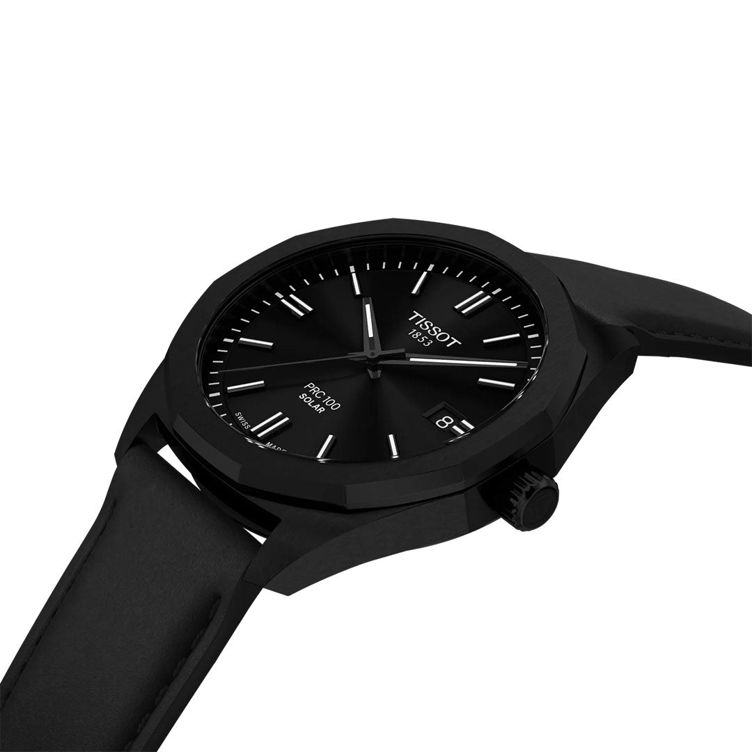 The Tissot PRC 100 Solar Quartz 39mm Watch features a black leather strap, black dial, silver hour markers, and a date window at 3 o’clock, shown angled against a white background.