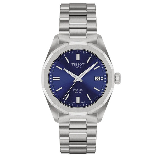 The Tissot PRC 100 Solar Quartz 34mm Watch features a stainless steel case, blue dial with silver markers and hands, date at 3 o’clock, “Tissot 1853” on the face, metal link band, and advanced solar-powered technology.
