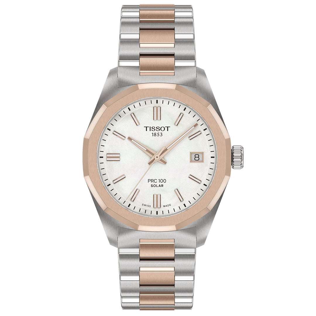 The Tissot PRC 100 Solar Quartz 34mm Watch features a white dial with gold hour markers, a date window at 3 o’clock, and a solar-powered quartz movement. It has a silver and rose gold metal band with rose gold bezel and center links.